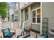 Inviting patio area featuring comfortable seating, a stylish coffee table, and a well-maintained green exterior at 5875 W Asbury Pl, Lakewood, CO 80227