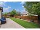 Spacious backyard featuring a well-maintained lawn, fence, and concrete patio at 11511 E 118Th Ave, Commerce City, CO 80640