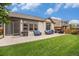 Backyard with outdoor seating, grill, patio, and well-maintained lawn at 11511 E 118Th Ave, Commerce City, CO 80640