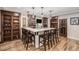 Basement bar area with marble countertop, cabinetry, and seating for six at 11511 E 118Th Ave, Commerce City, CO 80640