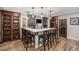 Basement bar area with marble countertop, cabinetry, and seating for six at 11511 E 118Th Ave, Commerce City, CO 80640