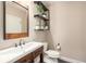 Cozy powder room featuring elegant wooden fixtures and stylish decor at 11511 E 118Th Ave, Commerce City, CO 80640