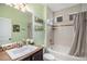 Cozy bathroom featuring a tub with tile surround, decorative shelving and a sleek vanity sink at 11511 E 118Th Ave, Commerce City, CO 80640