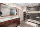 Stylish bathroom with modern shower, floating shelves and elegant wooden vanity at 11511 E 118Th Ave, Commerce City, CO 80640