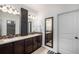 Bathroom with dual sinks, elegant mirrors, and modern finishes at 11511 E 118Th Ave, Commerce City, CO 80640