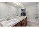 Bathroom featuring a white vanity, granite countertop, and ample natural light at 11511 E 118Th Ave, Commerce City, CO 80640