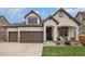 Charming home featuring a two-car garage, front porch with seating, and stucco siding accented by stone at 11511 E 118Th Ave, Commerce City, CO 80640