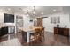 Kitchen featuring an island with seating, stainless steel appliances, and dark cabinets with dark hardwood floors at 11511 E 118Th Ave, Commerce City, CO 80640