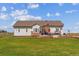 Charming home with large windows, outdoor patio, and lush backyard featuring mature landscaping at 527 Antelope E Dr, Bennett, CO 80102