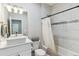 Modern bathroom featuring a vessel sink, marble-look tile, and shower with decorative accents at 527 Antelope E Dr, Bennett, CO 80102