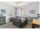 Bedroom with a ceiling fan, two windows, and decor at 527 Antelope E Dr, Bennett, CO 80102