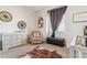 This bedroom features multiple pieces of furniture including a crib, changing table, and rocking chair at 527 Antelope E Dr, Bennett, CO 80102