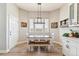 Bright dining area featuring white chairs, a table and bench and a view to the outdoors at 527 Antelope E Dr, Bennett, CO 80102