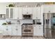 Bright kitchen featuring stainless steel appliances, white cabinets, and spacious countertops for cooking and entertaining at 527 Antelope E Dr, Bennett, CO 80102
