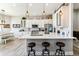 Bright kitchen with white cabinetry, quartz countertops, stainless steel appliances and modern pendant lighting at 527 Antelope E Dr, Bennett, CO 80102