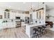 Stylish kitchen with white cabinetry, stainless steel appliances, marble countertop island, and pendant lighting at 527 Antelope E Dr, Bennett, CO 80102