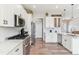 Modern kitchen with stainless steel appliances, white cabinets, and ample counter space at 527 Antelope E Dr, Bennett, CO 80102