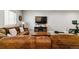 Relaxing living room features a sectional sofa, wooden coffee table and TV for movie nights at 527 Antelope E Dr, Bennett, CO 80102