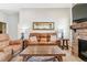Relaxing living room features a stone fireplace and comfortable brown seating, perfect for gatherings at 527 Antelope E Dr, Bennett, CO 80102