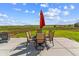 Outdoor patio with a dining table and chairs with views of the backyard and open landscape at 527 Antelope E Dr, Bennett, CO 80102