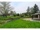 Spacious backyard with mature trees, a patio area, and well-maintained landscaping, perfect for outdoor living and entertaining at 11310 W Center Ave, Lakewood, CO 80226