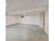 Spacious basement with concrete flooring, good lighting, and plenty of storage at 11310 W Center Ave, Lakewood, CO 80226