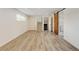 Finished basement space with wood flooring, a staircase, and access to a laundry area at 11310 W Center Ave, Lakewood, CO 80226