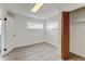 Bedroom with hardwood floors, large windows for natural light, and closet at 11310 W Center Ave, Lakewood, CO 80226