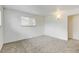 Clean and bright bedroom with large window, neutral colors and new carpet at 11310 W Center Ave, Lakewood, CO 80226