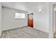 Neutral bedroom featuring closet, carpet, and window providing natural light at 11310 W Center Ave, Lakewood, CO 80226