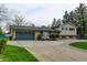 Charming home featuring an attached two-car garage, and mature trees surrounding the property at 11310 W Center Ave, Lakewood, CO 80226