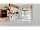 Clean kitchen with white appliances, a breakfast bar, and sliding glass doors to the backyard at 11310 W Center Ave, Lakewood, CO 80226