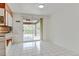 Clean kitchen with white appliances, a breakfast bar, and sliding glass doors to the backyard at 11310 W Center Ave, Lakewood, CO 80226