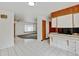Open concept kitchen with tiled breakfast bar, and white tiled floor at 11310 W Center Ave, Lakewood, CO 80226