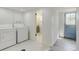 Convenient laundry room with washer, dryer, and utility sink, near backdoor at 11310 W Center Ave, Lakewood, CO 80226