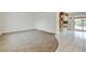 Bright living room with neutral carpet, tile floors, and an open floor plan leading to the kitchen at 11310 W Center Ave, Lakewood, CO 80226