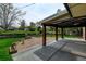 Inviting covered patio with flagstone extending into the yard, perfect for outdoor entertaining and relaxation at 11310 W Center Ave, Lakewood, CO 80226