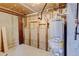 Unfinished basement space featuring a new State ProLine water heater ready for completion with storage and utility access at 11310 W Center Ave, Lakewood, CO 80226