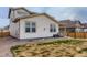 Exterior view of the home with a backyard, gravel landscaping, and patio at 17786 Olive St, Broomfield, CO 80023