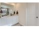 Bathroom featuring double sinks, a vanity with a stylish countertop, and modern fixtures at 17786 Olive St, Broomfield, CO 80023