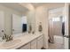 Bathroom featuring double vanity, marble countertop, and a shower-tub combination at 17786 Olive St, Broomfield, CO 80023