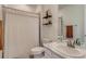 Bright bathroom featuring a shower with a curtain and a vanity with a stylish countertop at 17786 Olive St, Broomfield, CO 80023