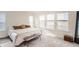 A sunlit bedroom featuring neutral tones, a comfortable bed, and multiple windows at 17786 Olive St, Broomfield, CO 80023