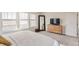 A well-lit bedroom features a comfortable bed, dresser, and large windows for plenty of light at 17786 Olive St, Broomfield, CO 80023