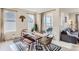 Stylish dining area with natural light, a modern table, seating, and easy access to the outdoor patio at 17786 Olive St, Broomfield, CO 80023