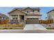 Charming two-story home with a two-car garage, solar panels, a front porch, and a well-manicured lawn at 17786 Olive St, Broomfield, CO 80023