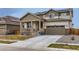 Charming two-story home with a two-car garage, solar panels, a front porch, and a well-manicured lawn at 17786 Olive St, Broomfield, CO 80023