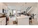 Elegant kitchen with a large island, bar stool seating, modern appliances, and an open layout connecting to the dining area at 17786 Olive St, Broomfield, CO 80023