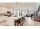 Open-concept kitchen with a large island, pendant lighting, and stainless steel appliances, seamlessly flowing into the living area at 17786 Olive St, Broomfield, CO 80023