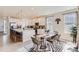 Bright, open kitchen with a large island, stylish barstools, and a dining area, perfect for entertaining at 17786 Olive St, Broomfield, CO 80023